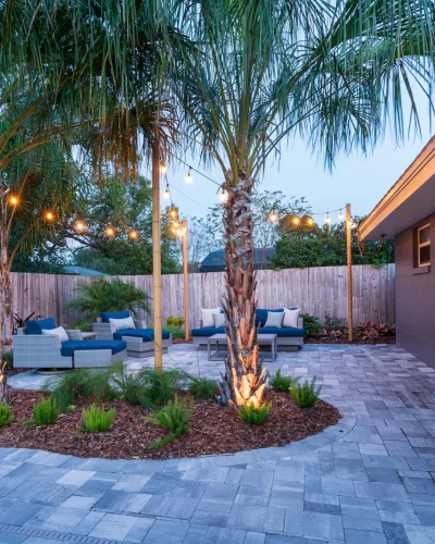 paver patio string lighting seating lounge chairs palm trees 3