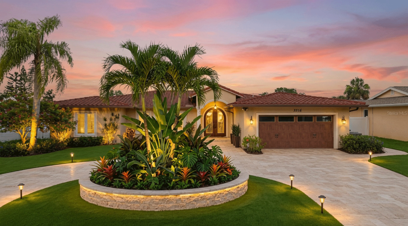 Custom outdoor landscape lighting and modern residential landscape redesign for a Clearwater estate at night.