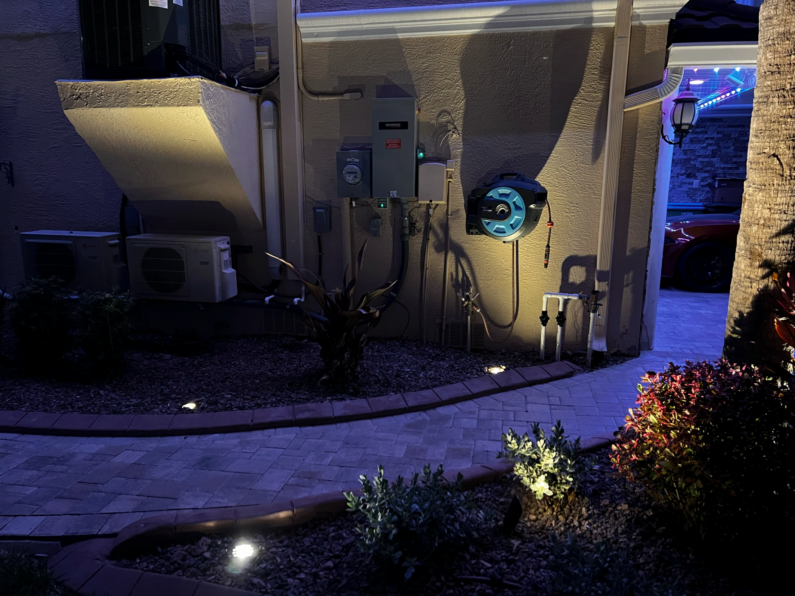 Example of bad landscape lighting highlighting AC units and electrical panels instead of landscaping